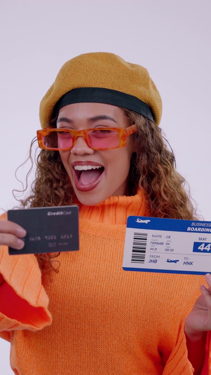 Excited Young Woman Holding Boarding Pass and Credit Card