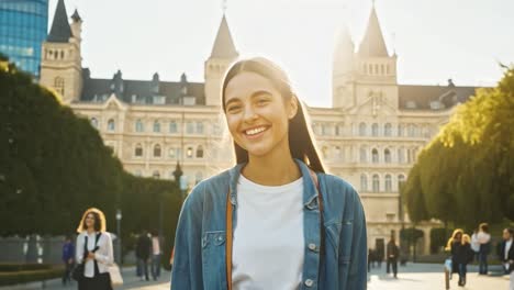 smiling woman in city with building and trees
