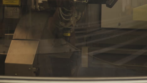 highly powered laser cutter shaping out numbers in iron beam