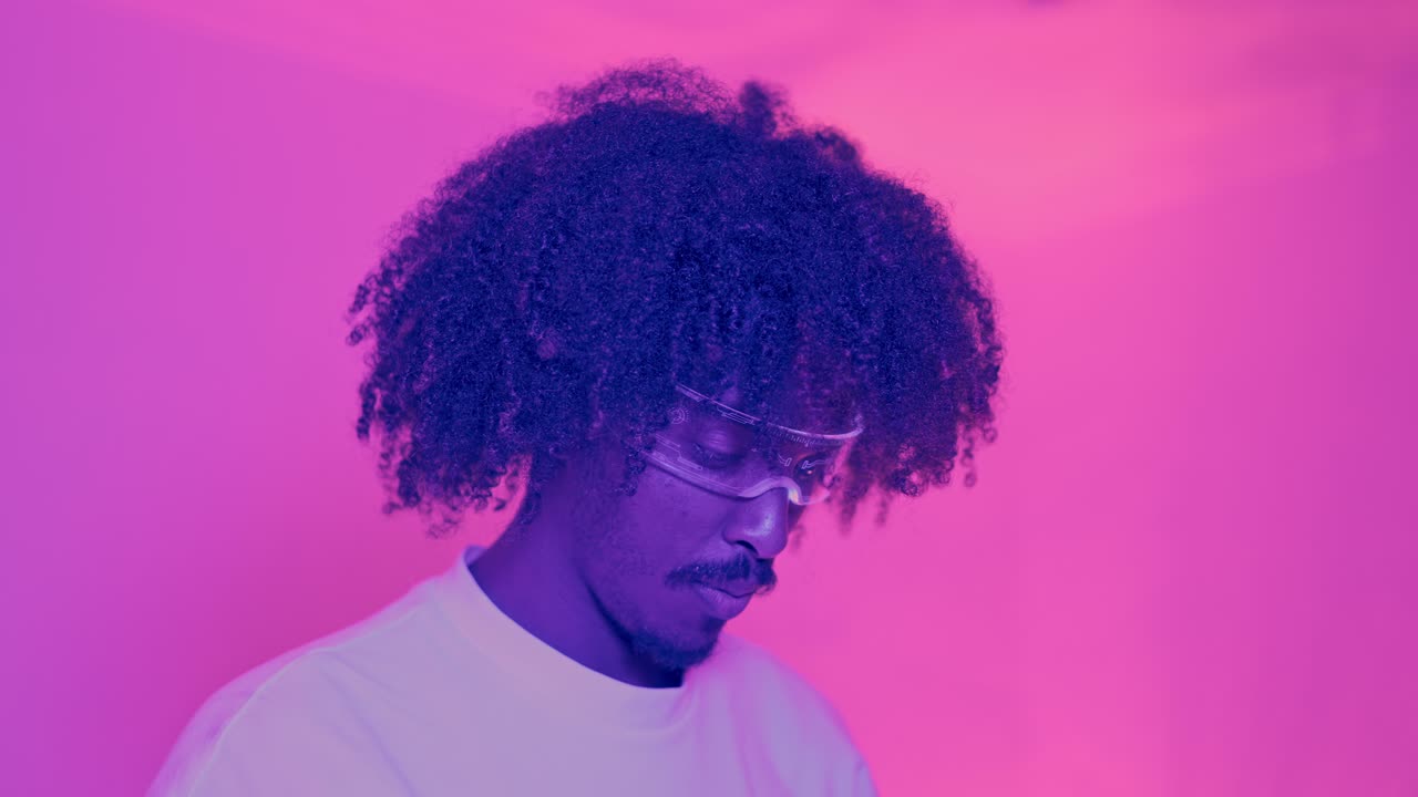 Person with futuristic glasses in neon pink light