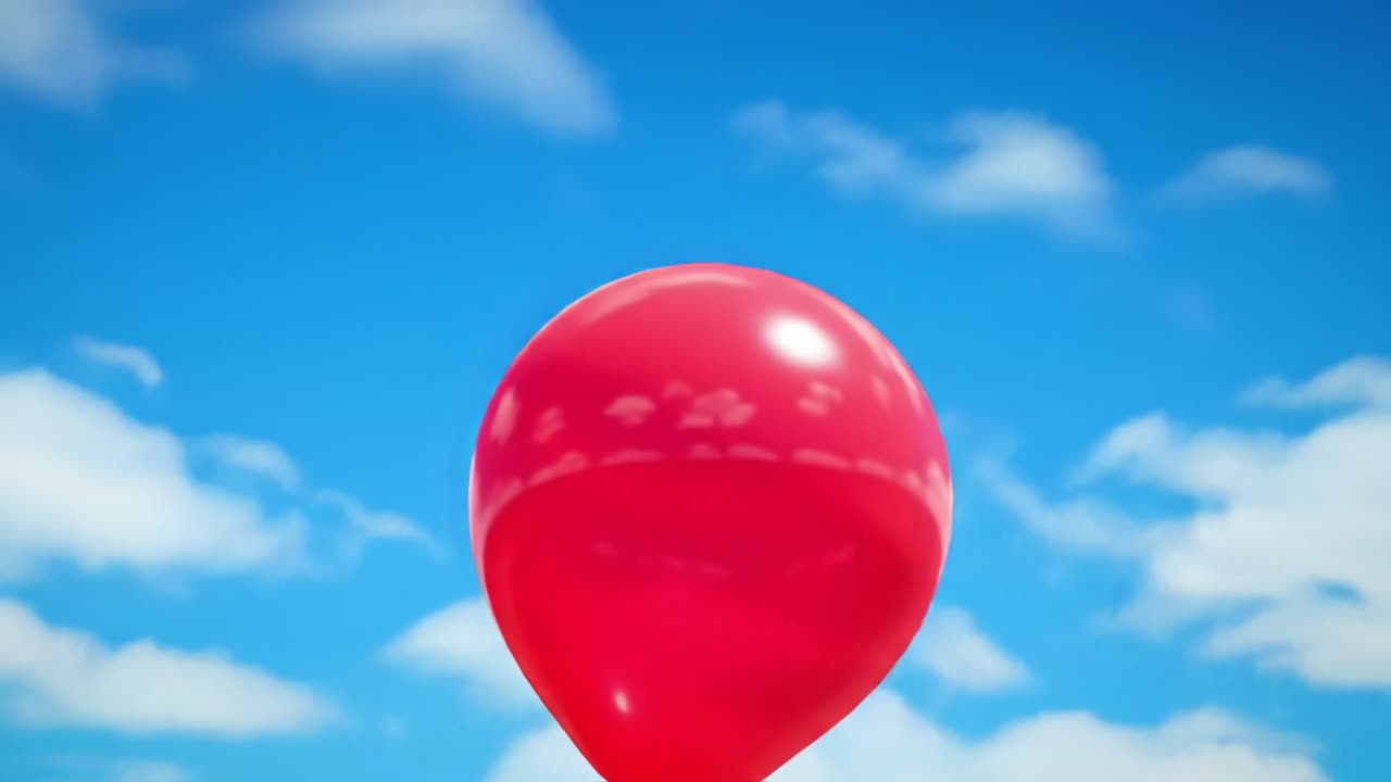 A vibrant red balloon drifts high into the sky, surrounded by fluffy white clouds on a sunny afternoon. The clear blue background enhances the cheerful atmosphere, capturing a moment of joy.