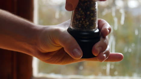Hand-Grinding-Pepper-From-A-Shaker