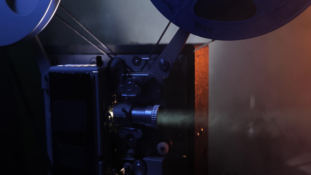 16mm movie projector in a smokey room