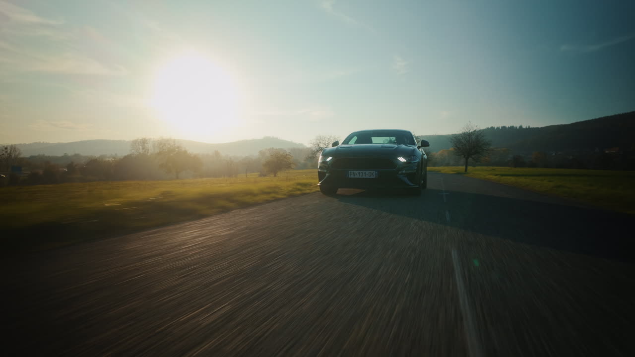 Ford Mustang Driving on a Country Road at Sunset