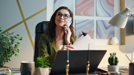 company worker speaking mobile phone at office table closeup. employee calling