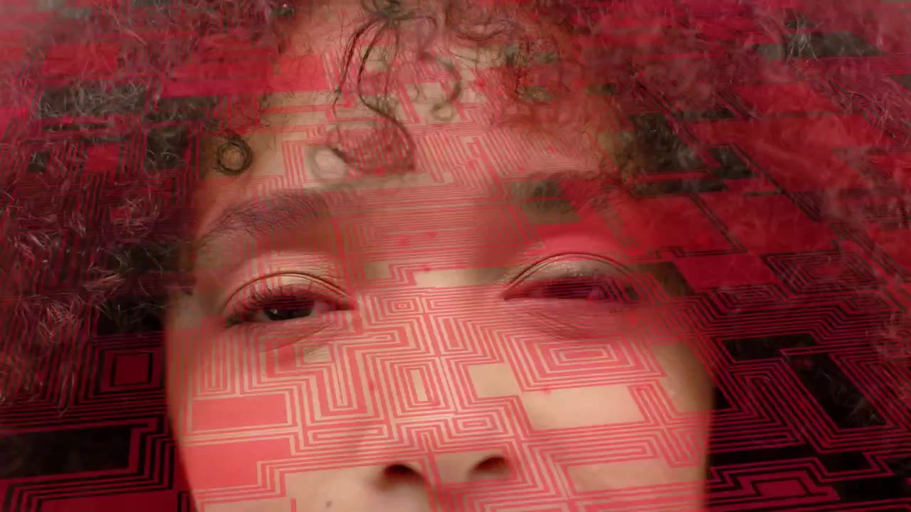 Woman in 20s opening eyes as red overlay shifting, revealing face in studio for tech effect