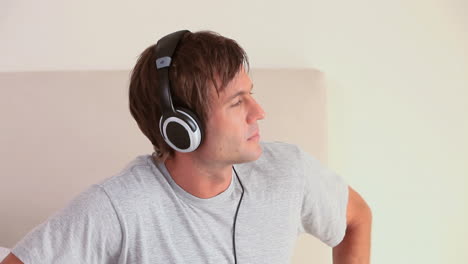 peaceful young man listening to music