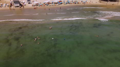 Individuals-Fishing-In-The-Sea-By-Using-A-Fishing-Net-To-Catch-Fish-At-The-Netanya-Beach,-Isreal