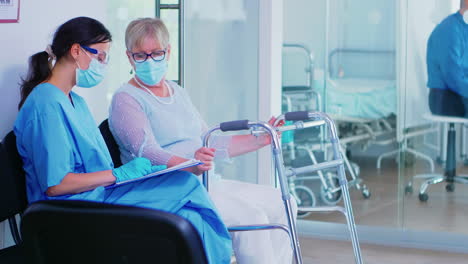 medical assistant filling documents for senior patient