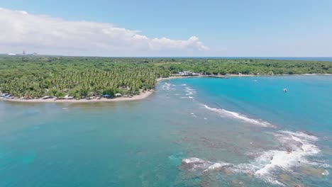 playa palenque with turquoise water and lush vegetation in san cristobal, dominican republic - aerial drone shot