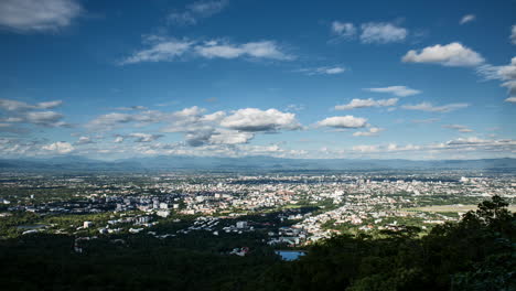 clouds moving through blue sky over chiang mai city in mountainous scenery, time lapse