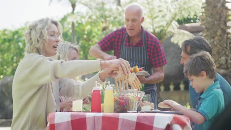 Happy-caucasian-family-having-barbecue-and-talking-in-garden