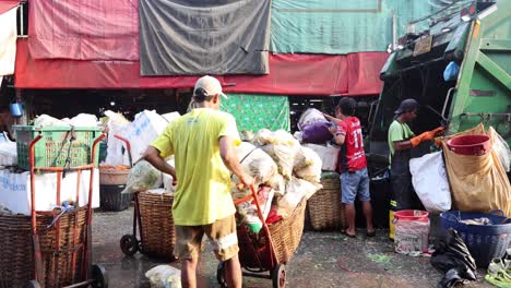 workers moving goods at a bustling outdoor market