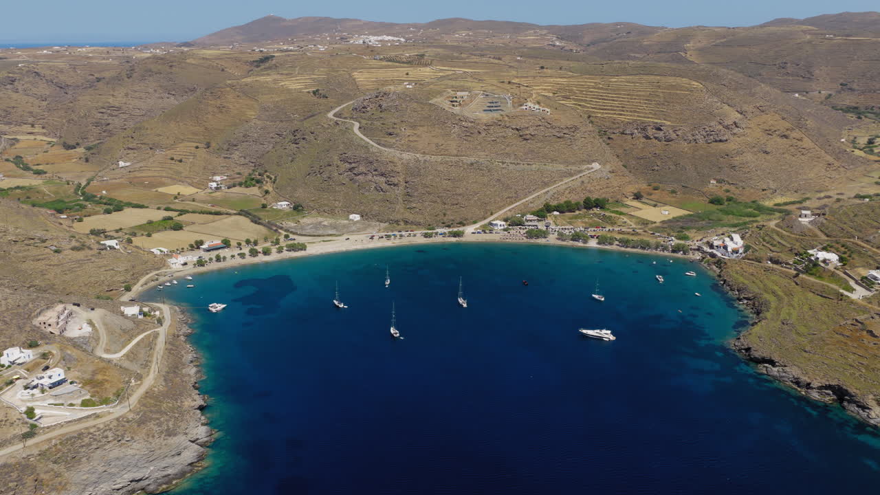 Slow panning drone shot of Apokrousi Beach in Kythnos island captured on a summer day, Cyclades, Greece