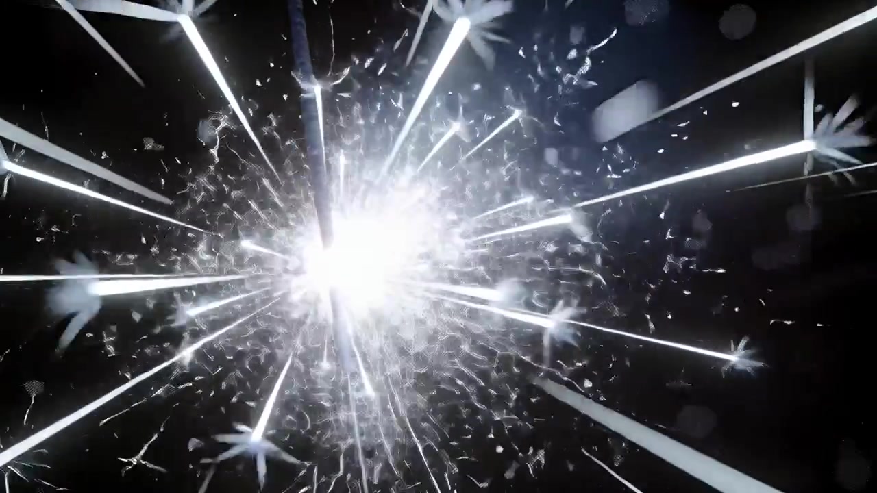 Bacchetta luminosa che emette scintille, proiettando strisce radiali in un primo piano scuro, seguendo il punto di accensione arancione.