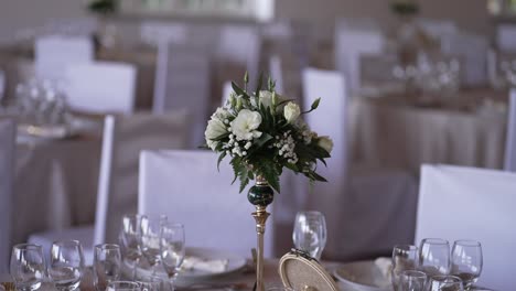 elegant wedding table setting with floral centerpiece and white decor