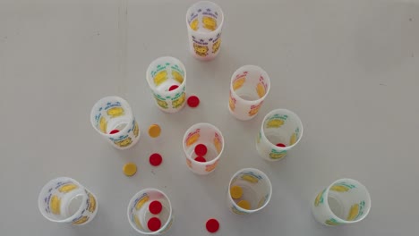 Kids-Game-with-Plastic-Cups-and-Coins-Thrown-in-to-the-Cups