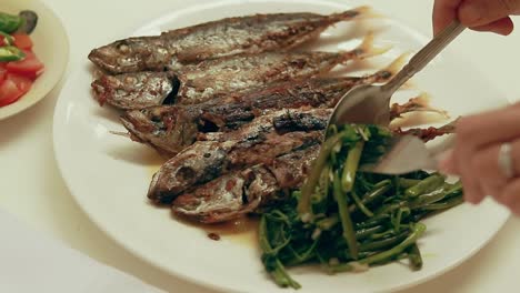 Pov-shot-of-eating-fried-galonggong-or-mackerel-scad-with-a-side-dish-of-stir-fried-kangkong-which-is-an-authentic-local-filipino-daily-food-from-the-Philippines