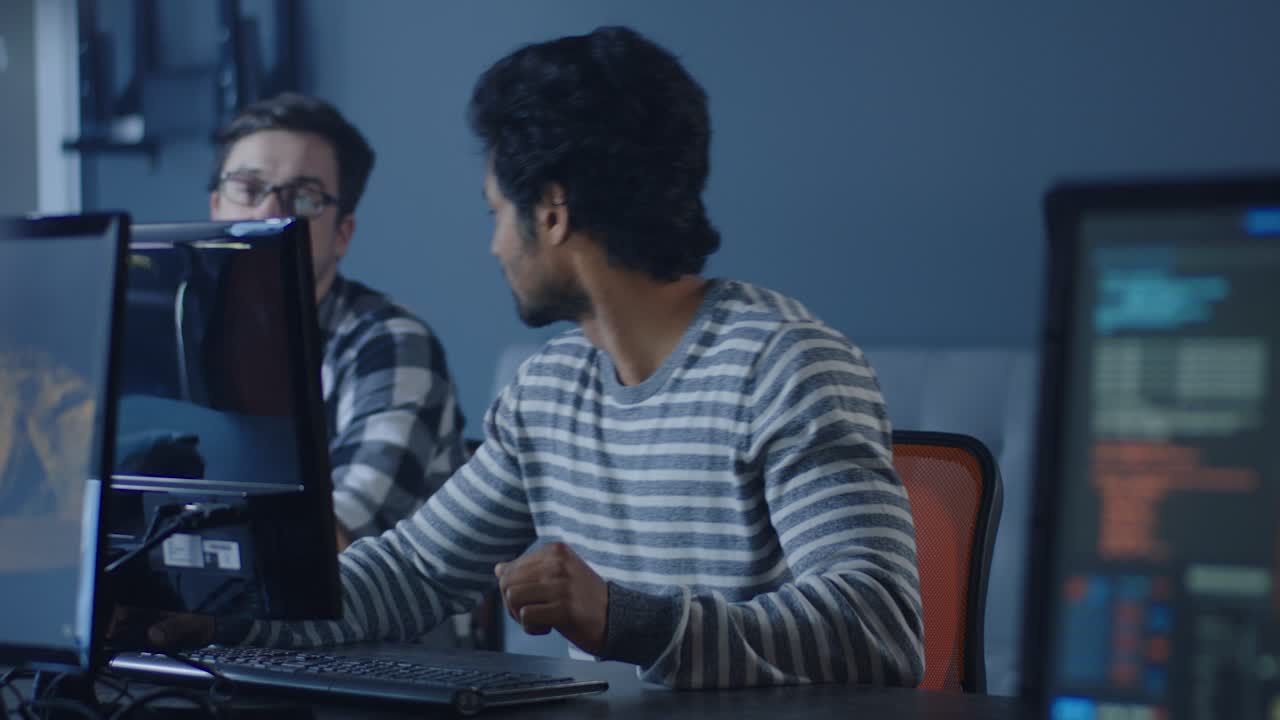 Two colleagues working together on computers