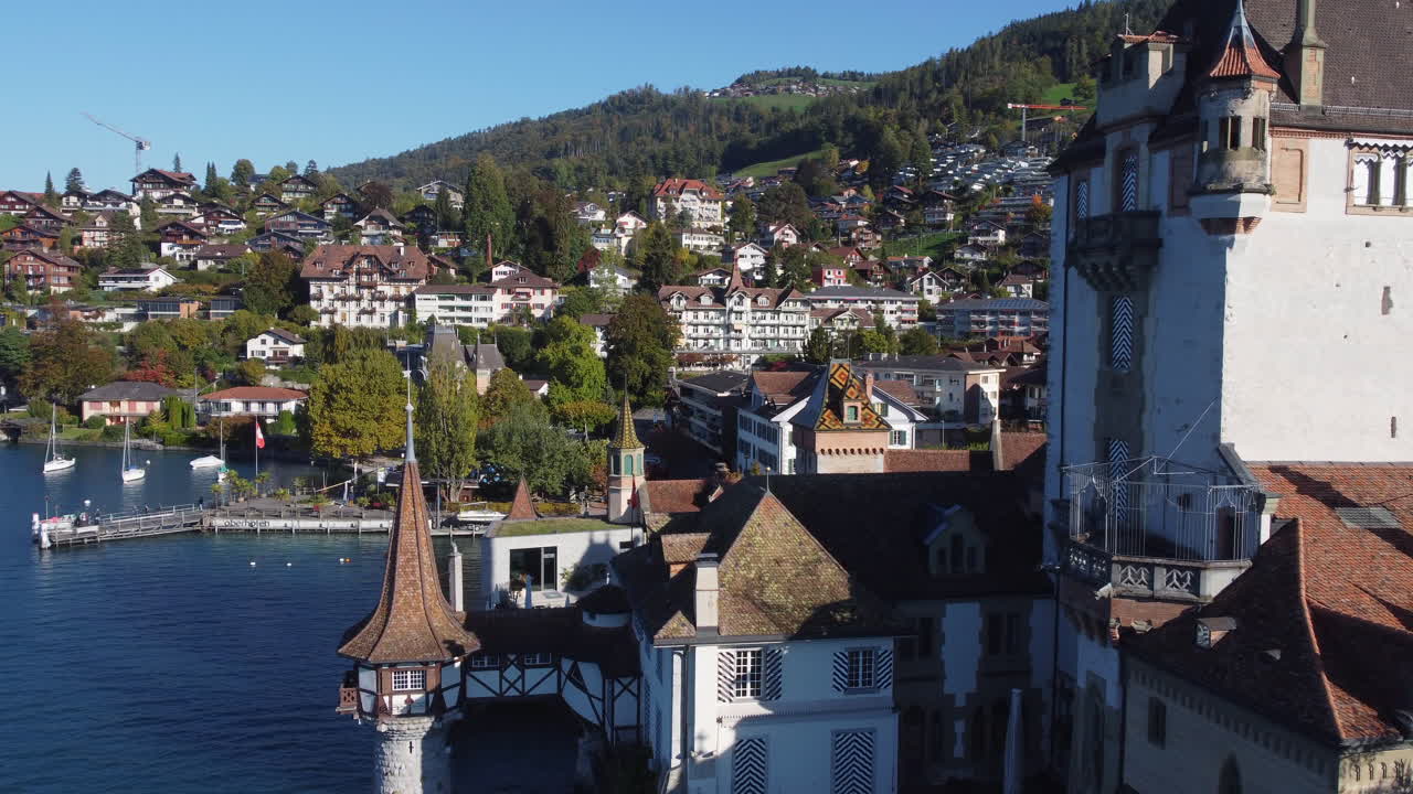 Aerial view of the medieval Oberhofen Castle with its lakeside turret on the shore of Lake Thun