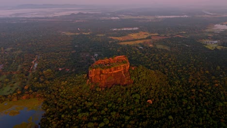 soaring above the misty jungles of sri lanka, this drone clip captures the iconic sigiriya rock at sunrise.