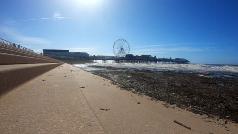 Stunning-aerial-view-of-the-famous-Blackpool-pier-at-high-tide,-by-the-award-winning-Blackpool-beach,-A-very-popular-seaside-tourist-location-in-England-,-United-Kingdom,-UK