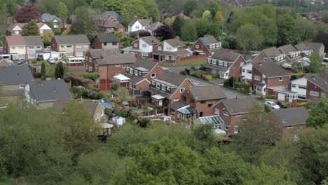 quiet british homes and gardens residential suburban property aerial view rising forwards