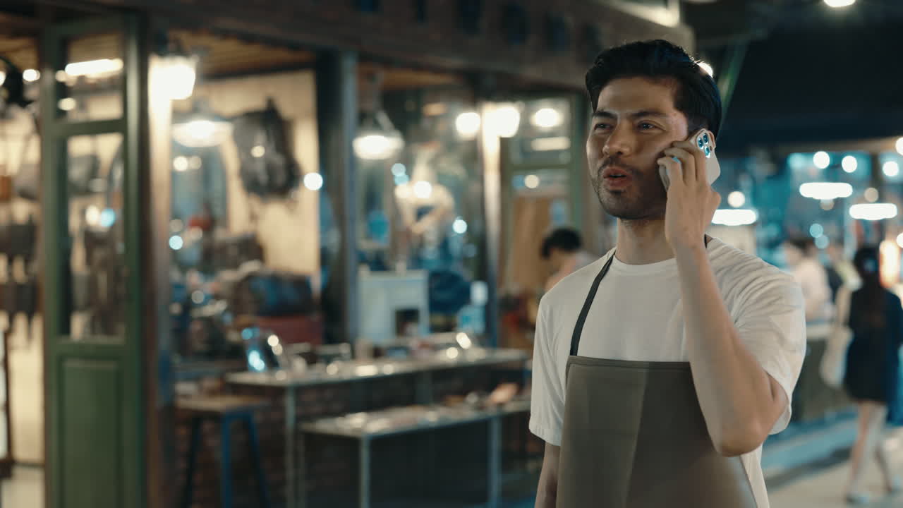 Man Talking on Phone at Night Market