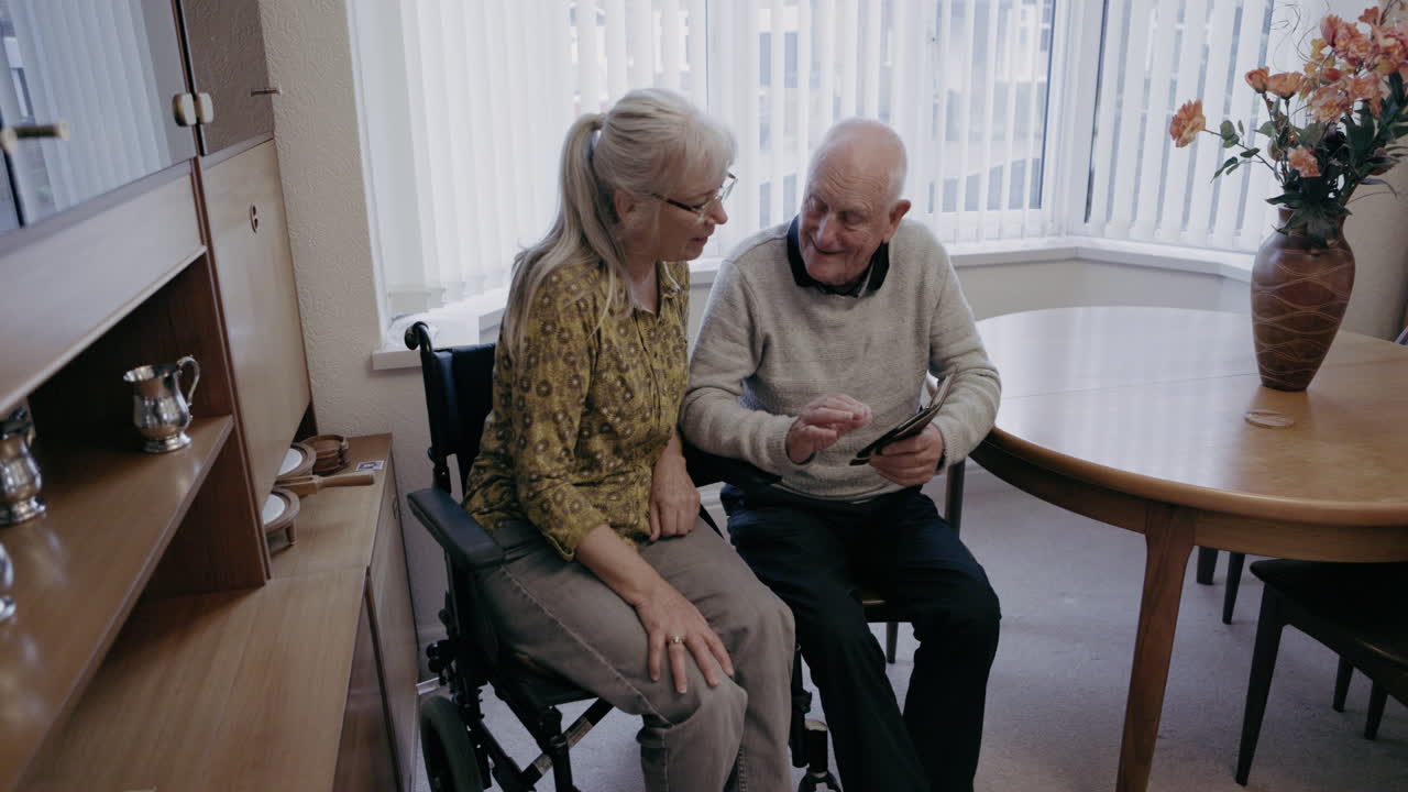 Elderly couple using a tablet at home