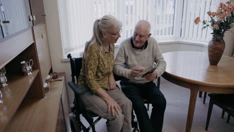 elderly couple using a tablet at home