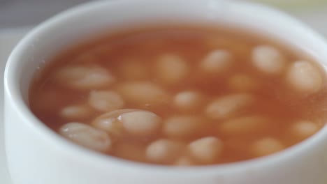 close-up of baked beans in a white bowl