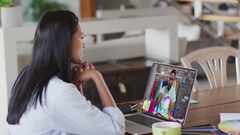 African-american-woman-having-a-video-call-with-male-colleague-on-laptop-at-home