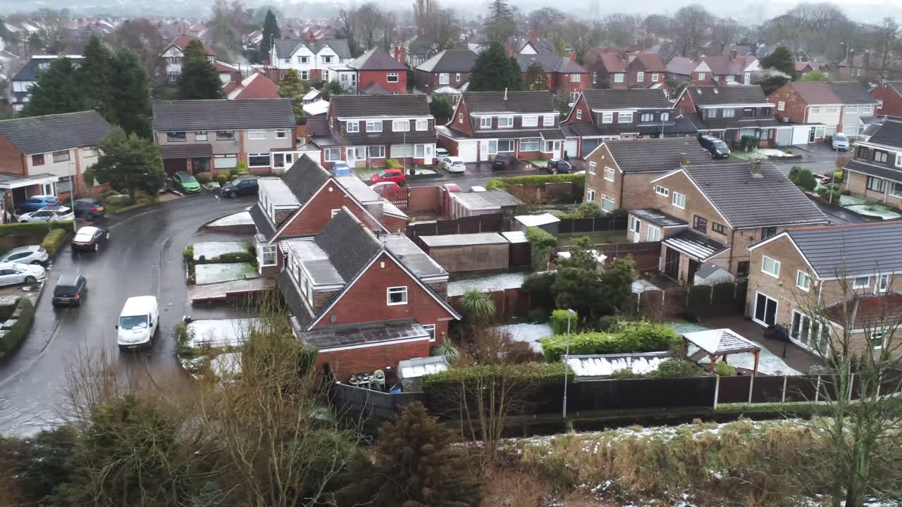 Snowy aerial village residential neighbourhood Winter frozen North West houses and roads low dolly right