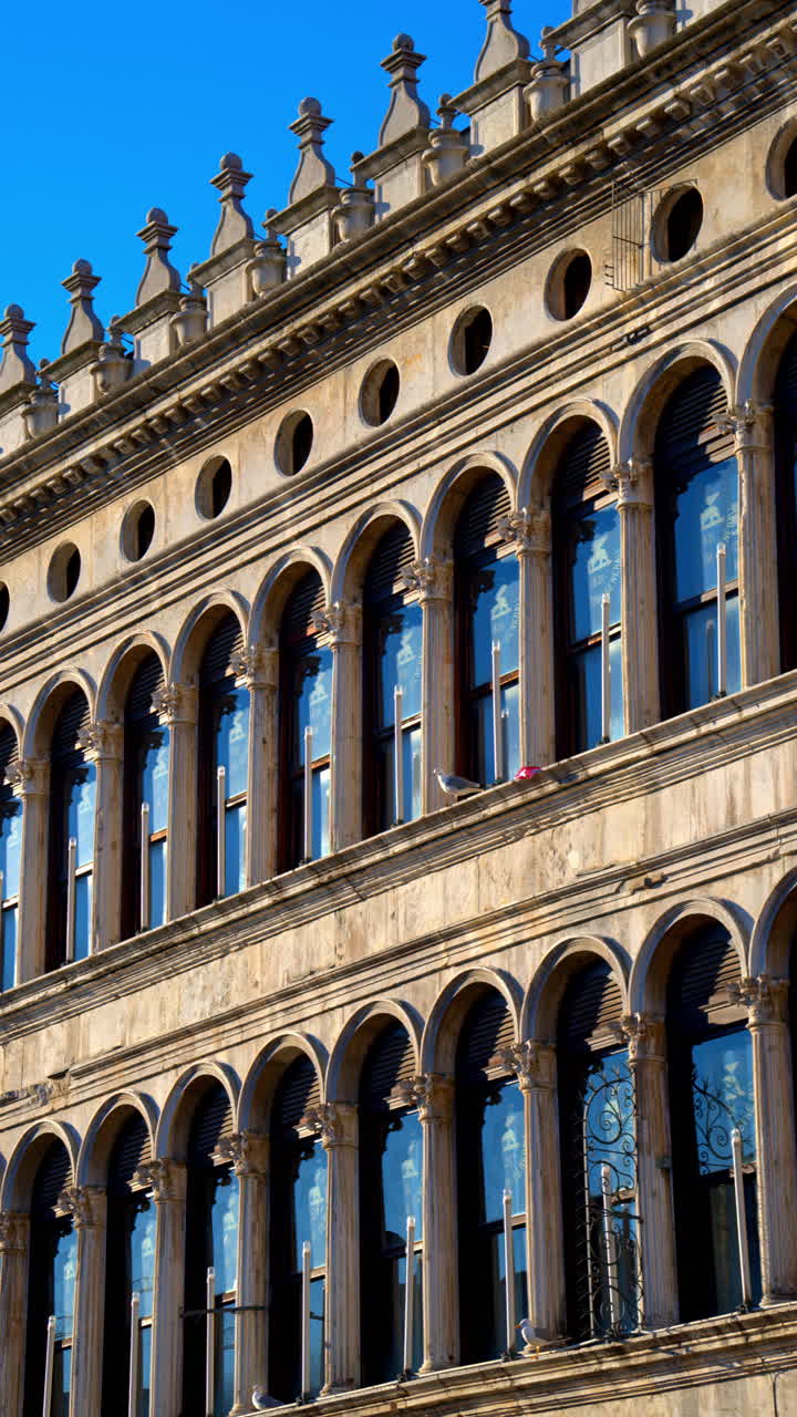 Building facade with arches in the St. Mark's Square in Venice, Italy. Vertical