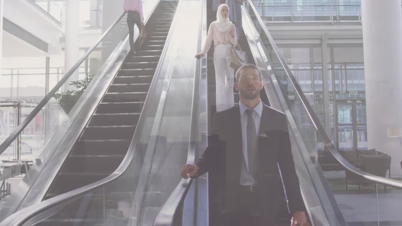 Homens e mulheres de negócios diversos usando escada rolante em edifício comercial, sobre paisagem urbana