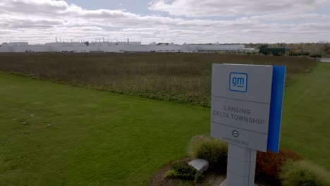 General-Motors-auto-plant-in-Delta-Township,-Michigan-with-drone-video-moving-forward-and-up-showing-sign-and-plant