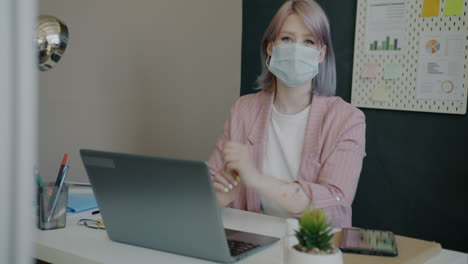 woman working from home with mask