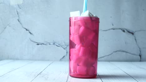 pink tumbler with sugar cubes