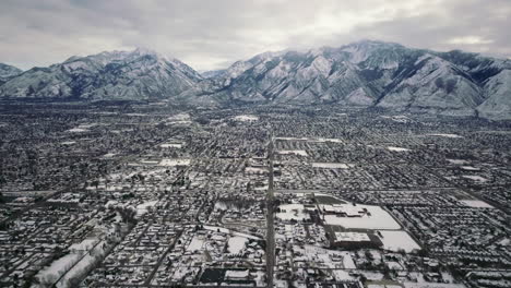 SLC-backward-reveal-Wasatch-Range-Utah-mid-winter-cold-snowy-fog-cloudy-high-city-scape-March-2019