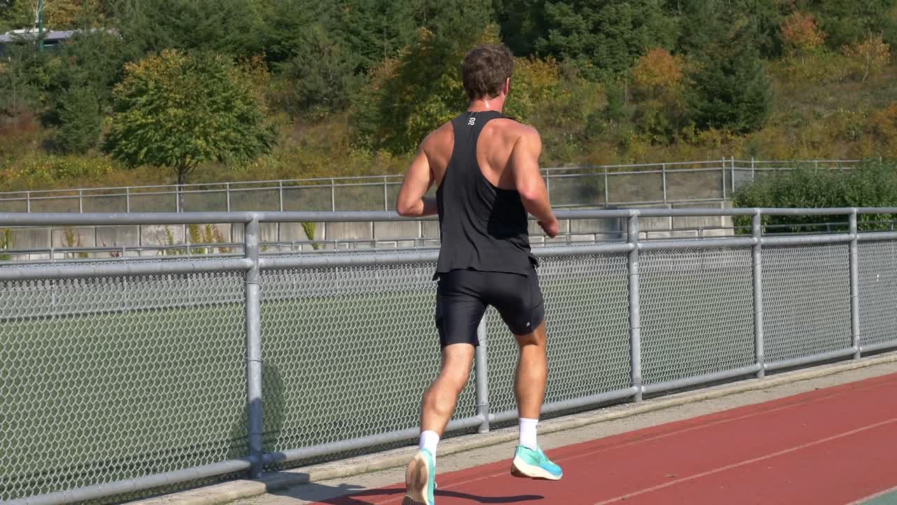 Sprinter trenujący na stadionie lekkoatletycznym latem