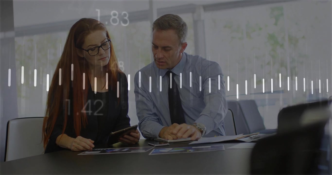 Business Professionals Analyzing Financial Data on Tablet in Office