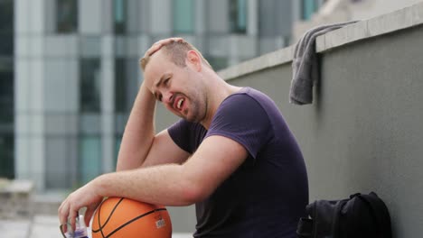 basketball player sitting in a basketball court 4k