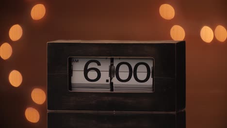 A-retro-flip-clock-flipping-to-6:00-AM