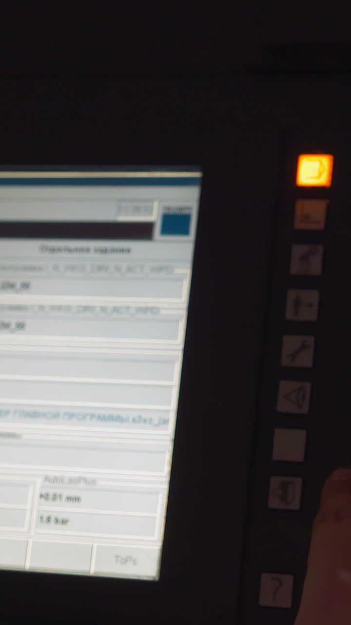 Engineer choosing program of machine tool operating in factory workshop closeup. Worker uses computing technology at production plant. Automatic equipment