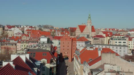 Aerial-Motion-Over-Street-Old-Buildings-With-Brown-Roofs