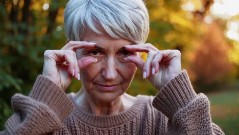 mature woman gesturing about eyesight and vision