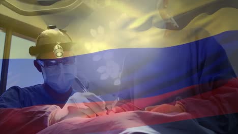 Animation-of-flag-of-colombia-waving-over-surgeons-in-operating-theatre