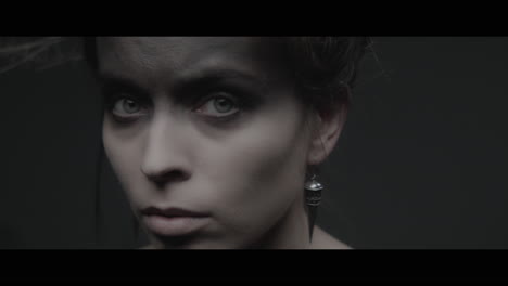 a woman dressed as mother nature turns her head and look into the camera