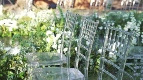 elegant outdoor wedding setup with transparent chairs and white flowers, luxury event design