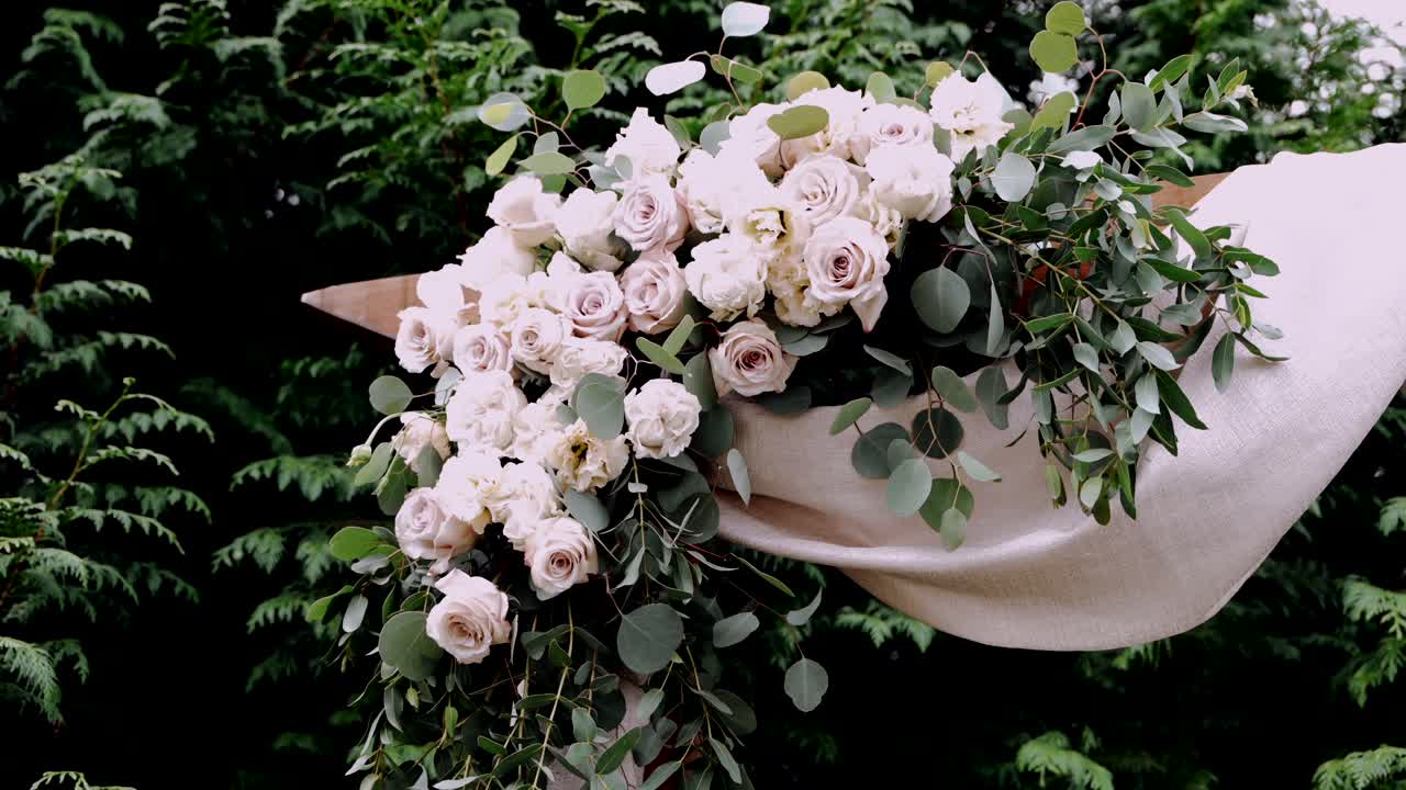 Elegant floral wedding arrangement with soft pink roses and greenery